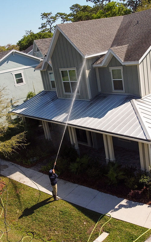 soft washing professional spraying home siding and roof
